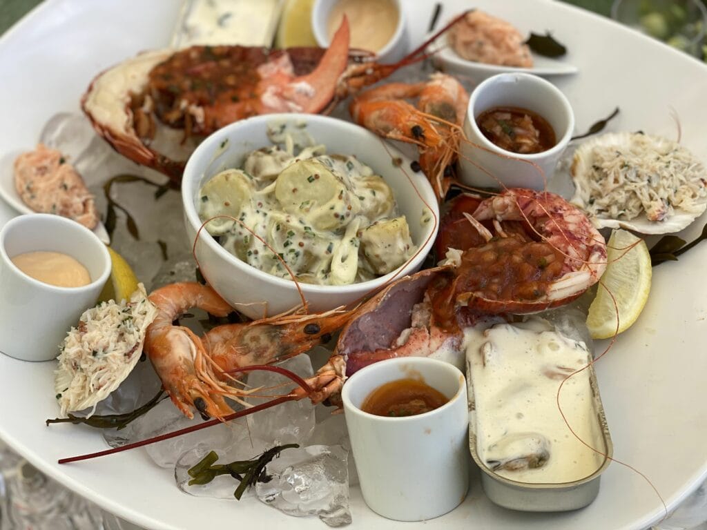 Luxury seafood platter at Wimbledon’s The Roof Top, featuring lobster, prawns, crab, and gourmet sides on a bed of ice