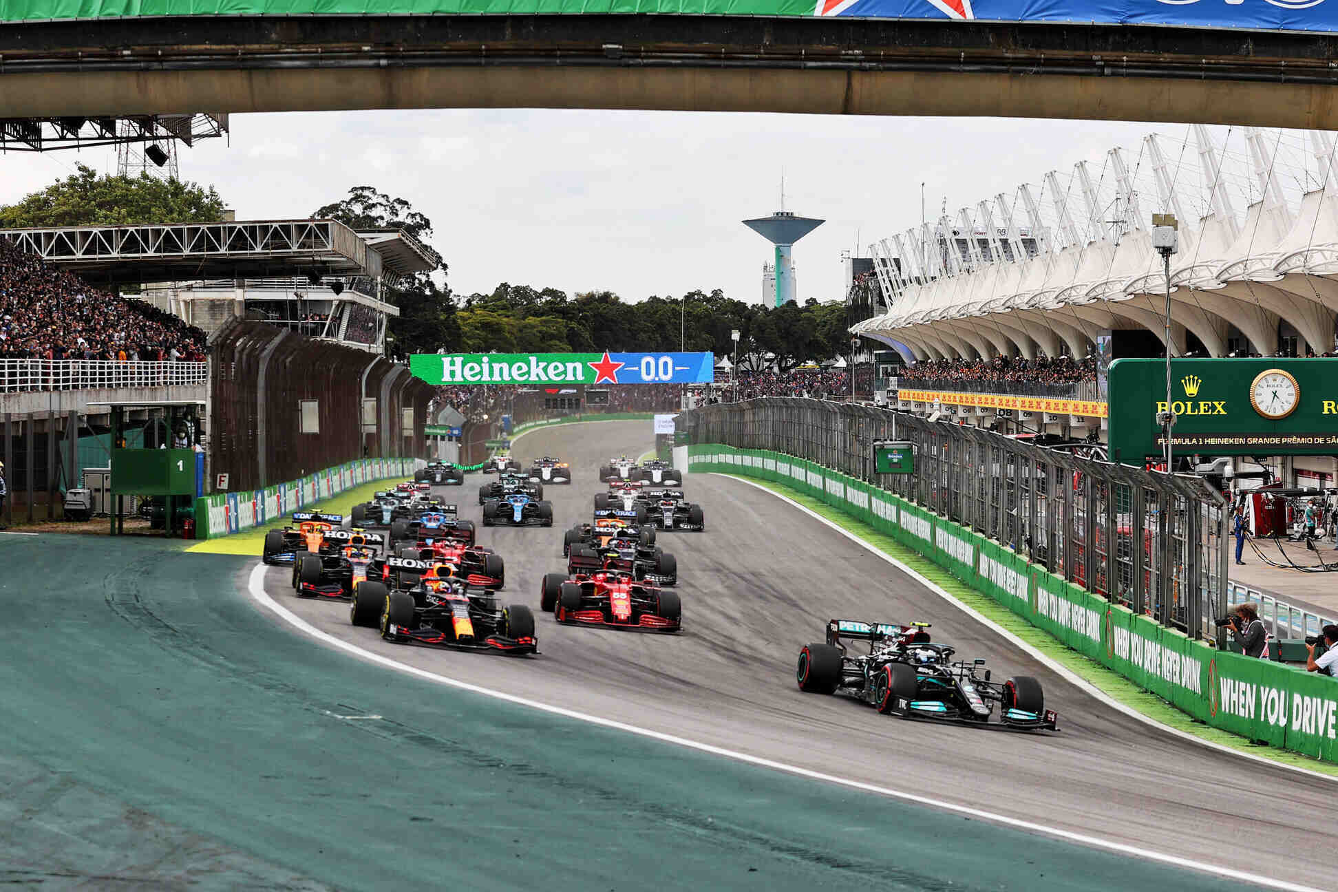 Formula 1 cars speed through the start line at the Brazilian Grand Prix, packed with fans and high-octane racing energy in São Paulo