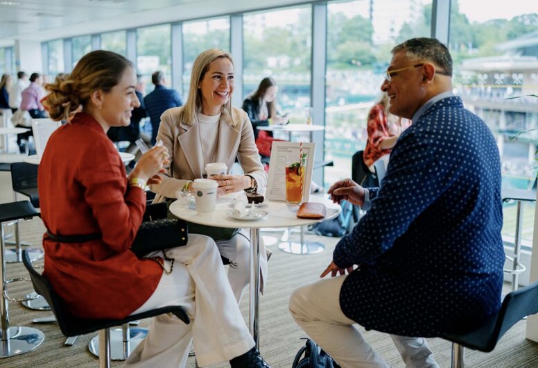 Guests enjoying coffee and conversation at Wimbledon’s The Gallery, a stylish lounge with panoramic views of the tournament grounds