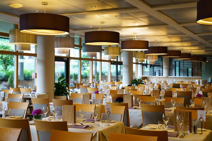 Elegant dining setup at Wimbledon’s Renshaw Restaurant, featuring modern lighting, stylish table arrangements, and a refined atmosphere