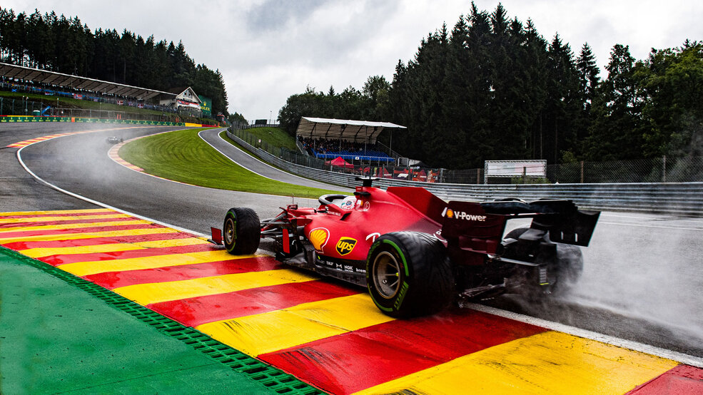 Ferrari Formula 1 car racing through Eau Rouge in wet conditions at the Belgian Grand Prix at Circuit de Spa-Francorchamps