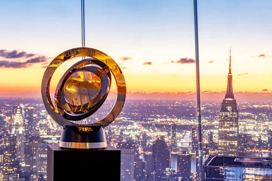 FIFA Club World Cup trophy displayed against a New York City skyline at sunset before the 2025 final