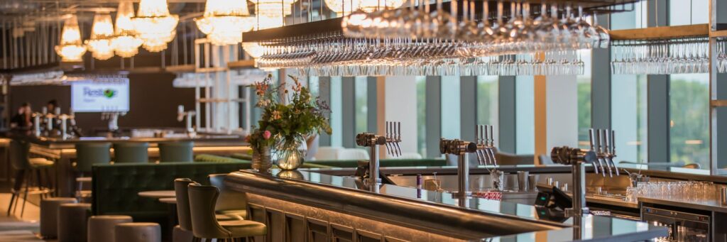 Elegant hospitality bar in The East Wing at Allianz Stadium Twickenham, offering a premium corporate event experience with modern furnishings and ambient lighting.