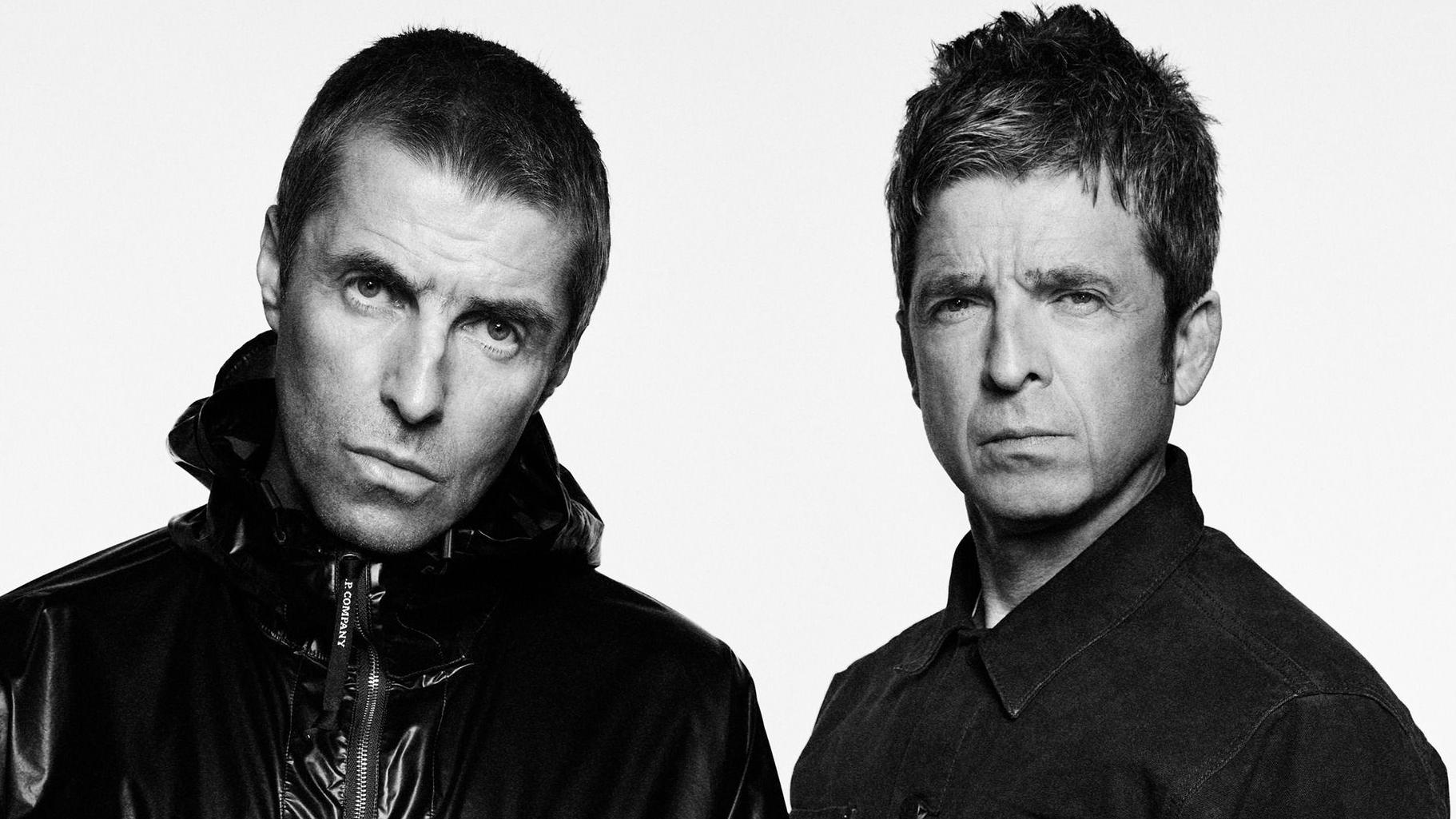Black and white portrait of Liam and Noel Gallagher of Oasis, both staring seriously at the camera against a plain background